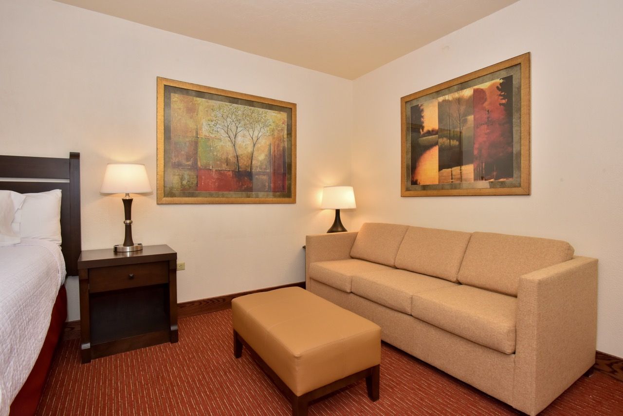 image Cozy suite featuring a plush bed, soft lighting, and a relaxing sitting area for ultimate comfort.