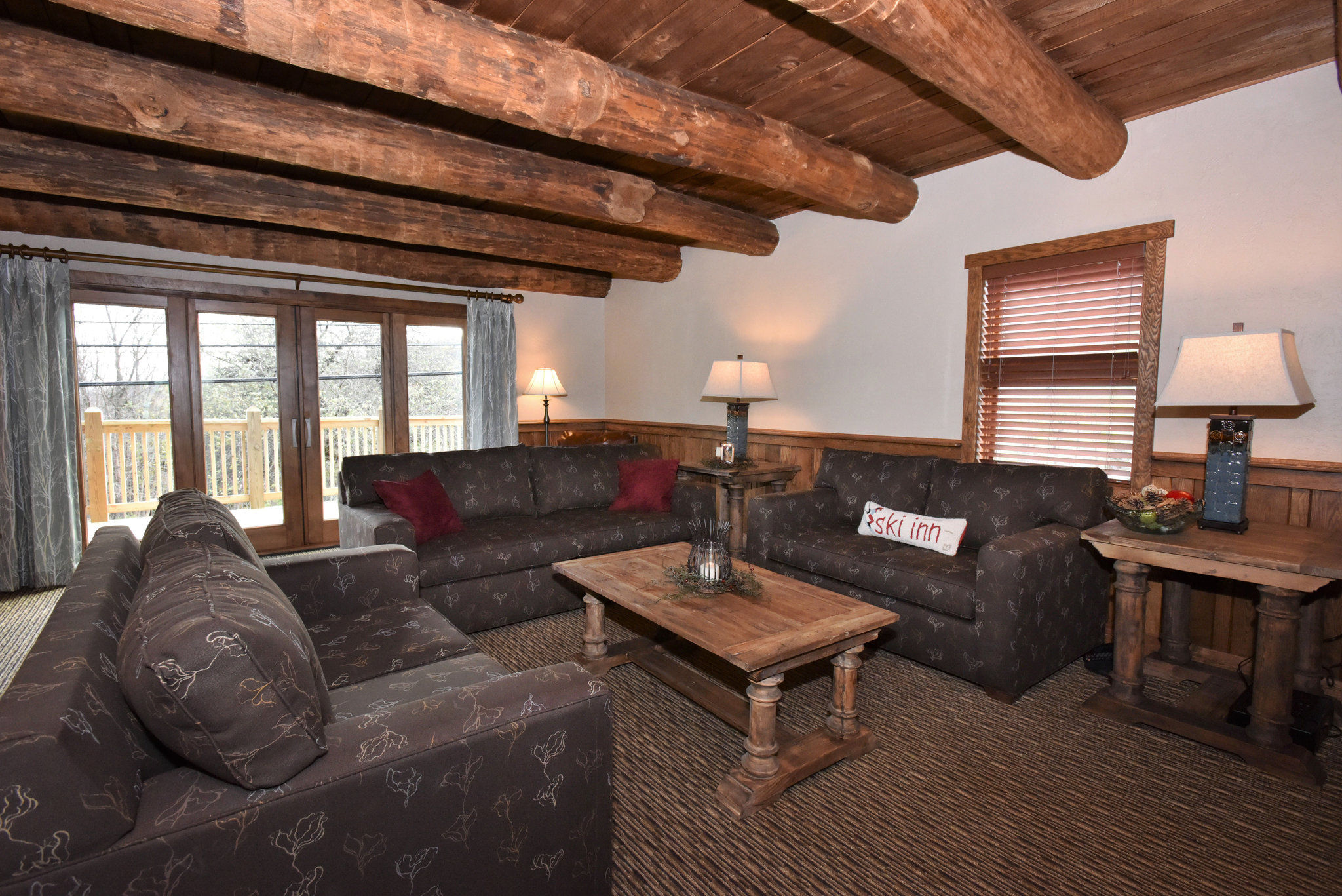 image Welcoming living space featuring exposed beams and plush seating, perfect for unwinding after a day of adventure.