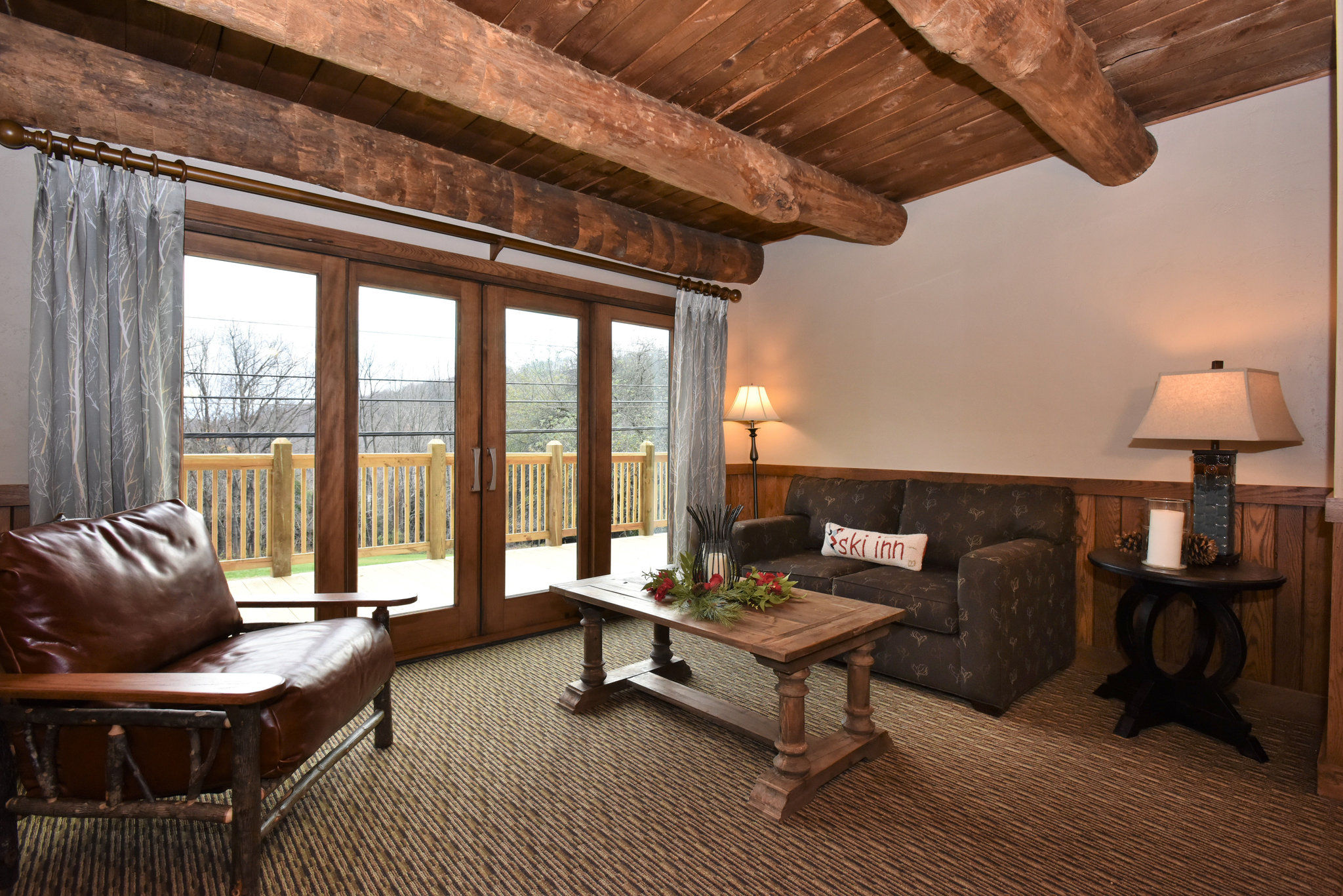 image  Relaxing living area with large windows and rustic decor, perfect for enjoying the view and unwinding.