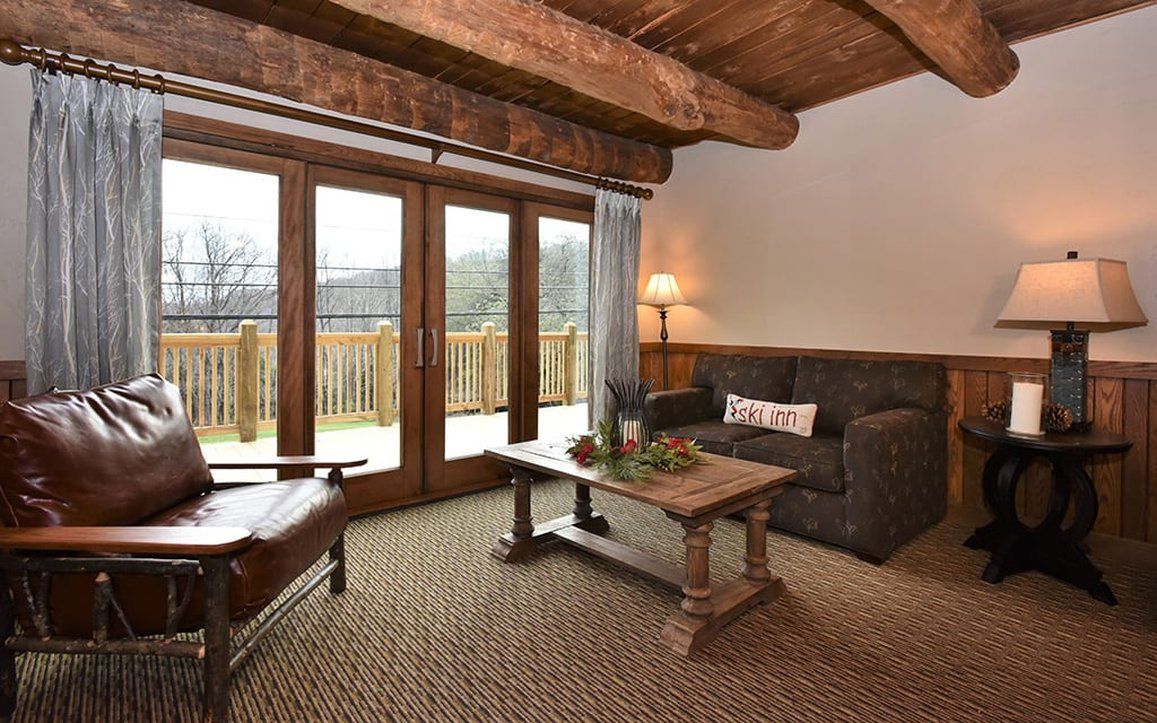 image Inviting living area with large windows and rustic decor, perfect for enjoying the views and cozy evenings indoors.