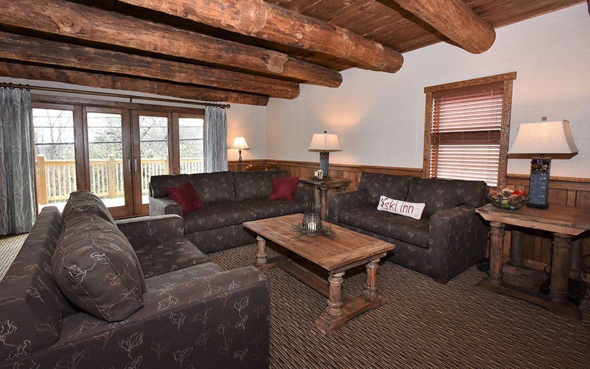 image Inviting living area with plush seating and a rustic touch, ideal for enjoying time with family and friends.
