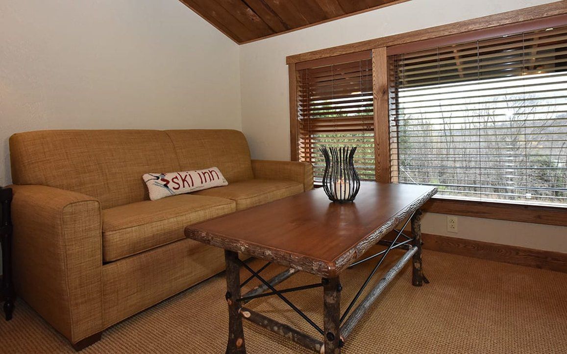 image Comfortable seating area with large windows, ideal for a quiet moment with a book or enjoying the natural light.