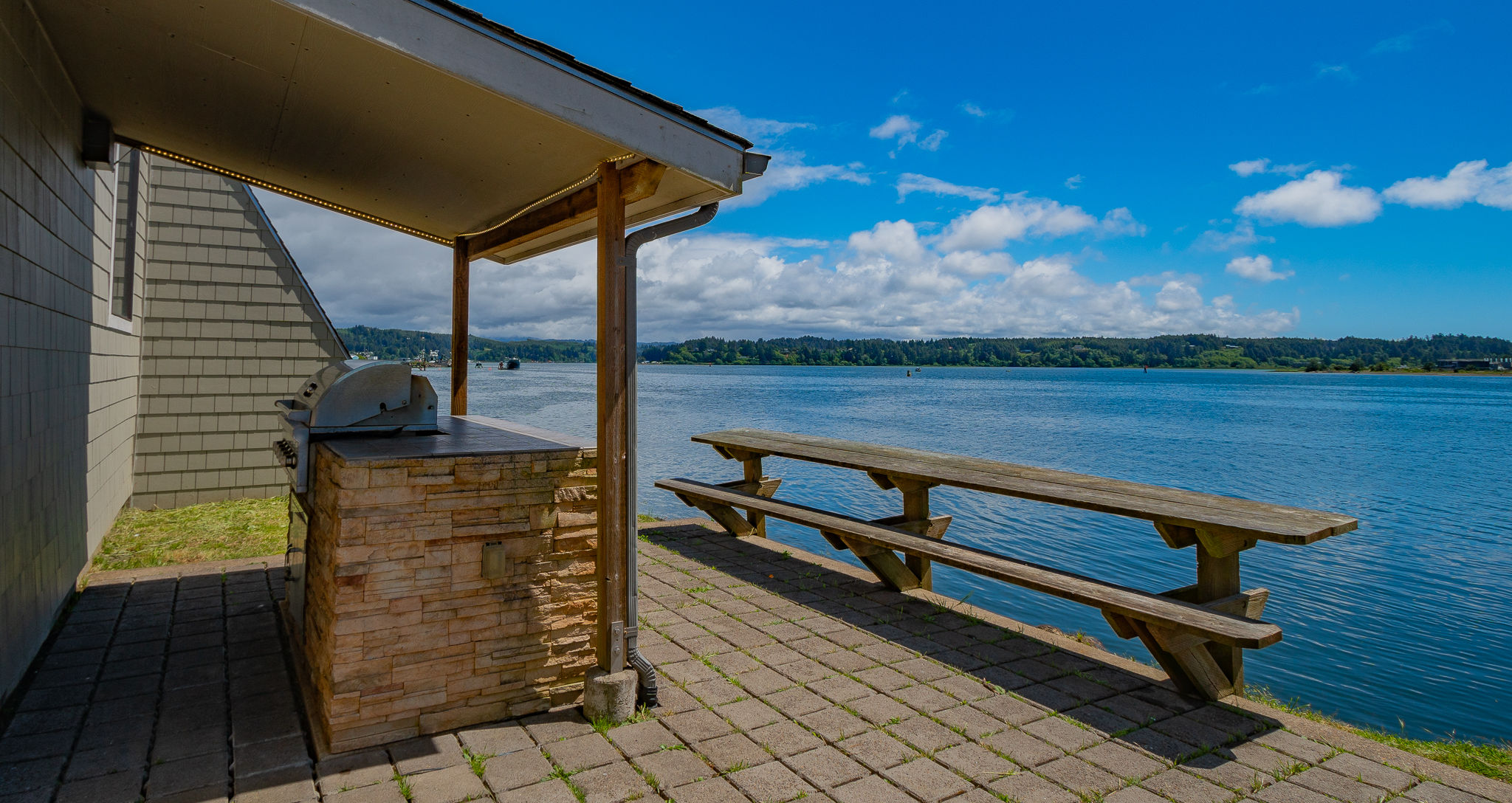 image Enjoy serene waterfront views from this peaceful outdoor seating area, perfect for dining al fresco or simply soaking in the tranquil surroundings.