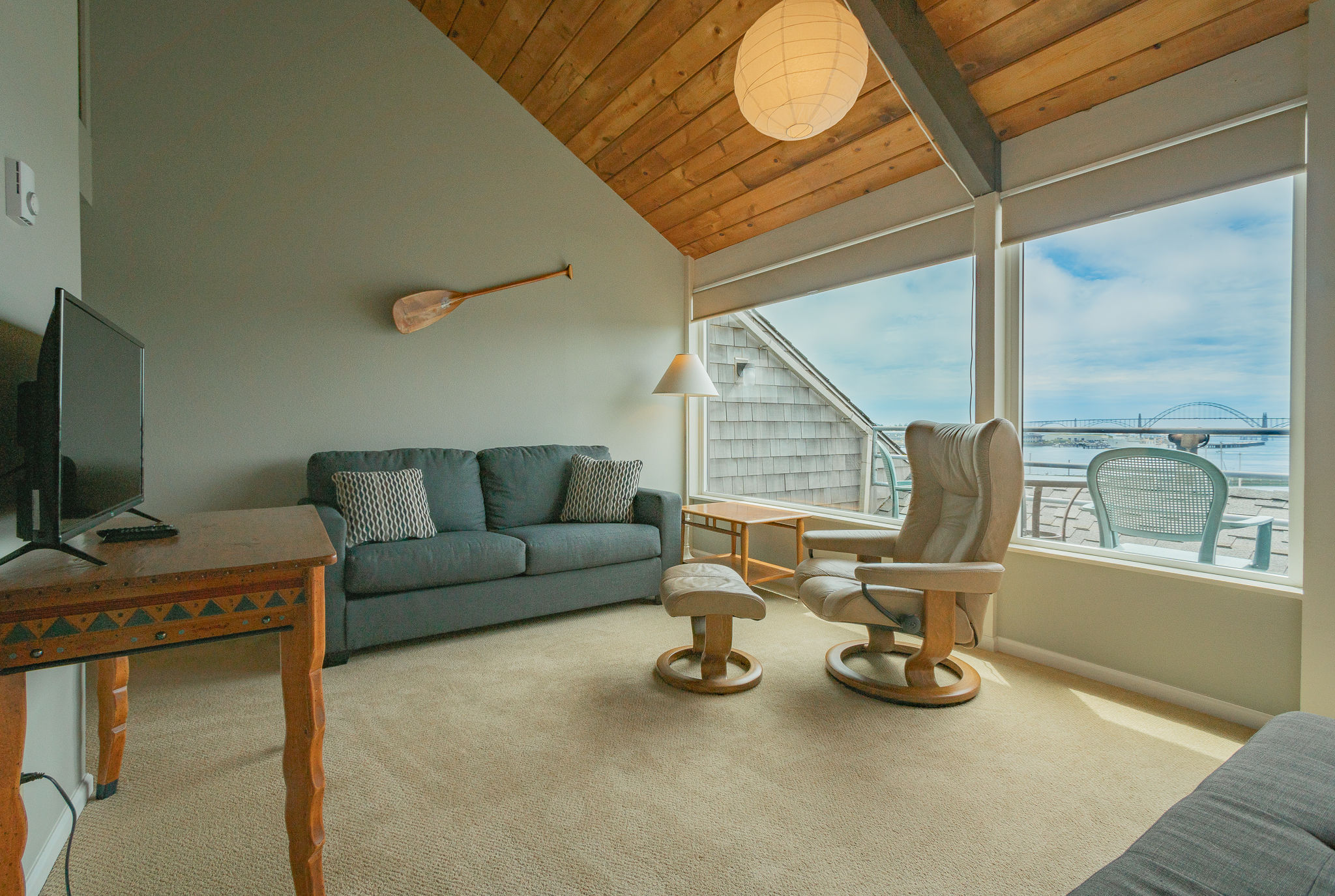 image This cozy living area features vaulted ceilings and expansive windows, offering stunning views and natural light.