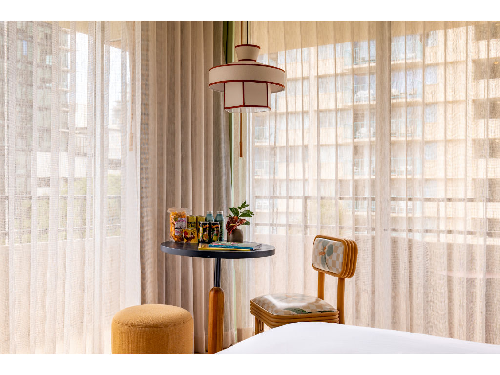 image Bask in the gentle sunlight filtering through the sheer curtains, creating a calm and soothing environment for unwinding and relaxation.
