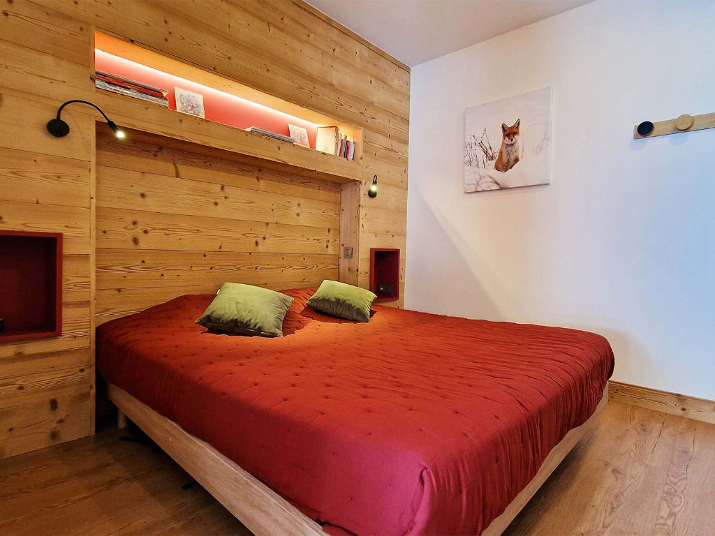 image Comfortable sleeping area with plush bedding and warm wood tones, providing a restful retreat in the heart of the mountains.