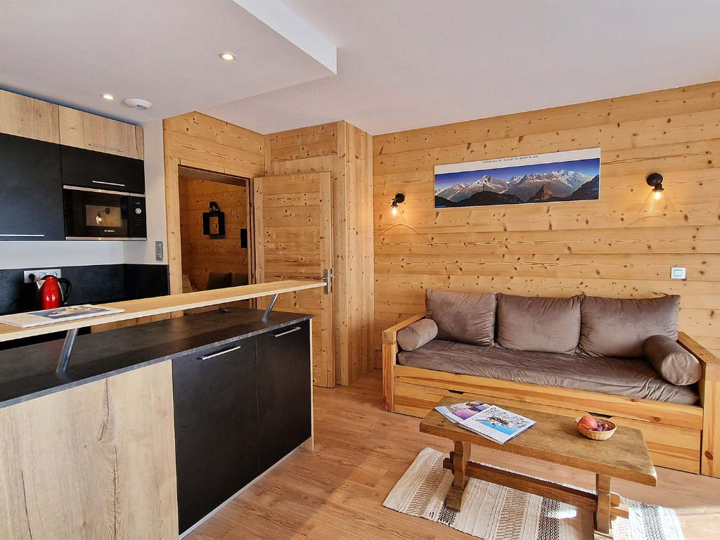 image Cosy and welcoming living space with rustic wooden accents, located just 100 meters from the pistes, lifts, and tourism office — perfect for relaxing after a day on the mountain.