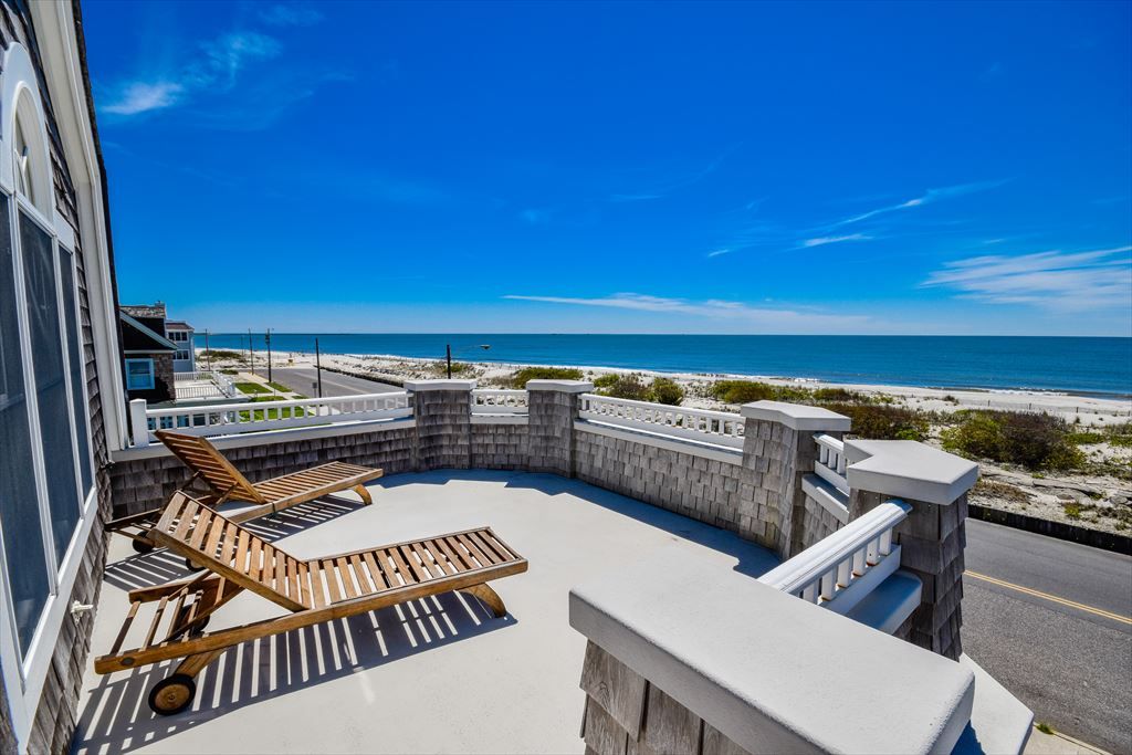 image Expansive oceanfront balcony with lounge seating, offering uninterrupted panoramic views of the coastline.
