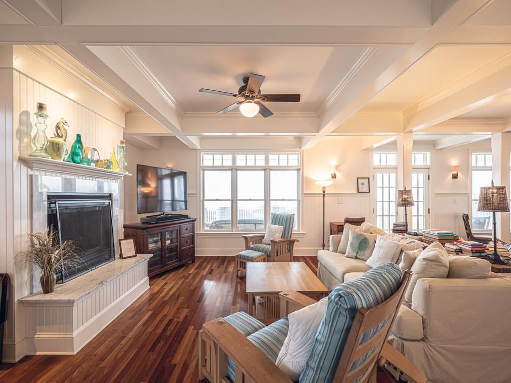 image Open-concept living area with stylish decor, abundant natural light, and seamless flow to the dining and kitchen areas.