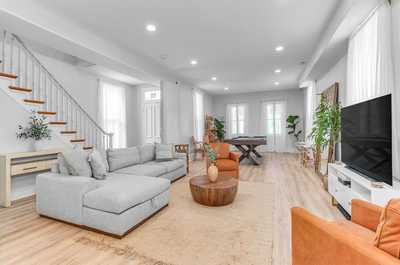 Stylish and spacious living room with modern decor and plenty of natural light.