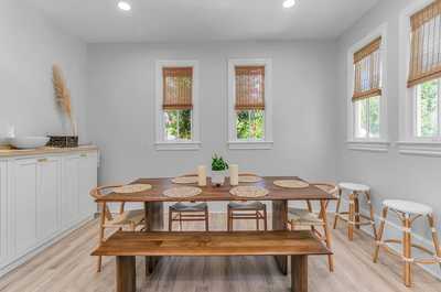 Cozy dining nook with ample seating for family meals and a warm, inviting atmosphere.