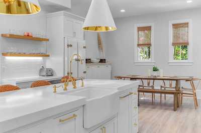 Farmhouse sink and beautiful natural light make this kitchen both functional and charming.