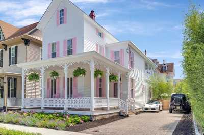 A stunning and spacious vacation rental with a welcoming front porch, perfect for relaxing after a day at the beach.