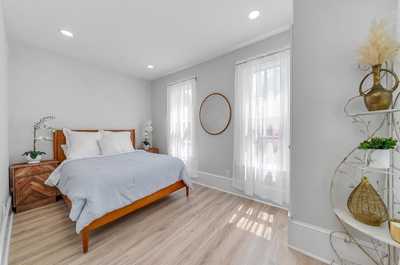 Bright and airy bedroom with a cozy queen bed and stylish minimalist design.