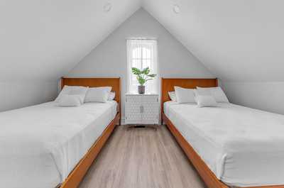 Another view of the attic bedroom, showcasing its generous space and inviting atmosphere.