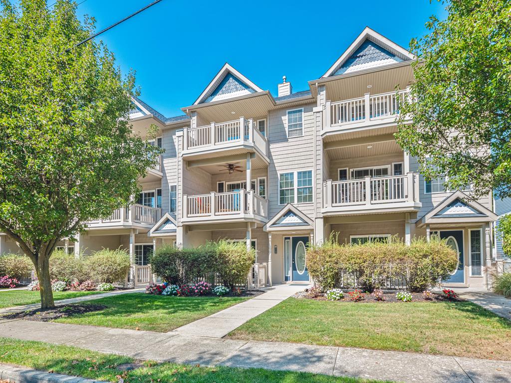 image Beautiful multi-level townhouse with charming balconies and lush landscaping, offering plenty of space for your group getaway.