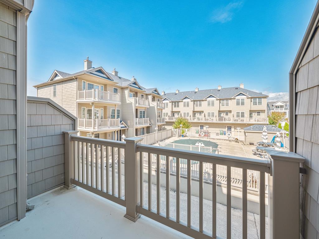 image Private balcony offering a serene view of the surrounding neighborhood, perfect for relaxing in the fresh air.
