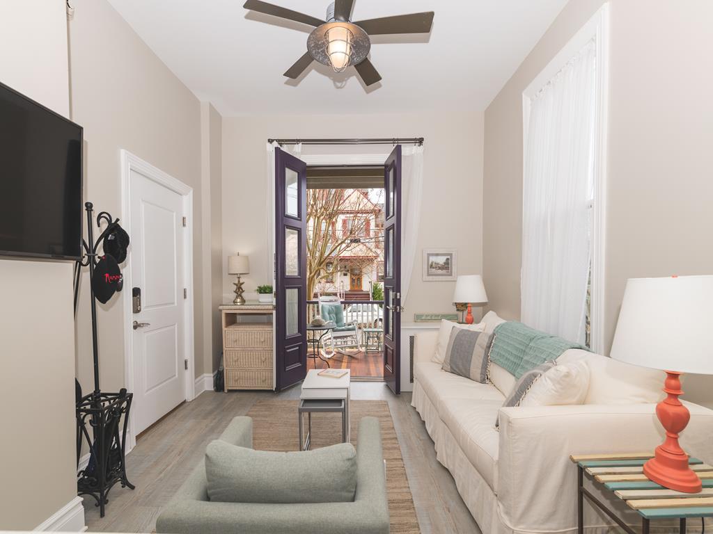 image The open-concept living area connects seamlessly to the private front porch, offering an airy and comfortable stay.