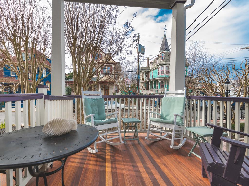 image Unwind on the private front porch with comfortable seating, offering a front-row view of historic Jackson Street.