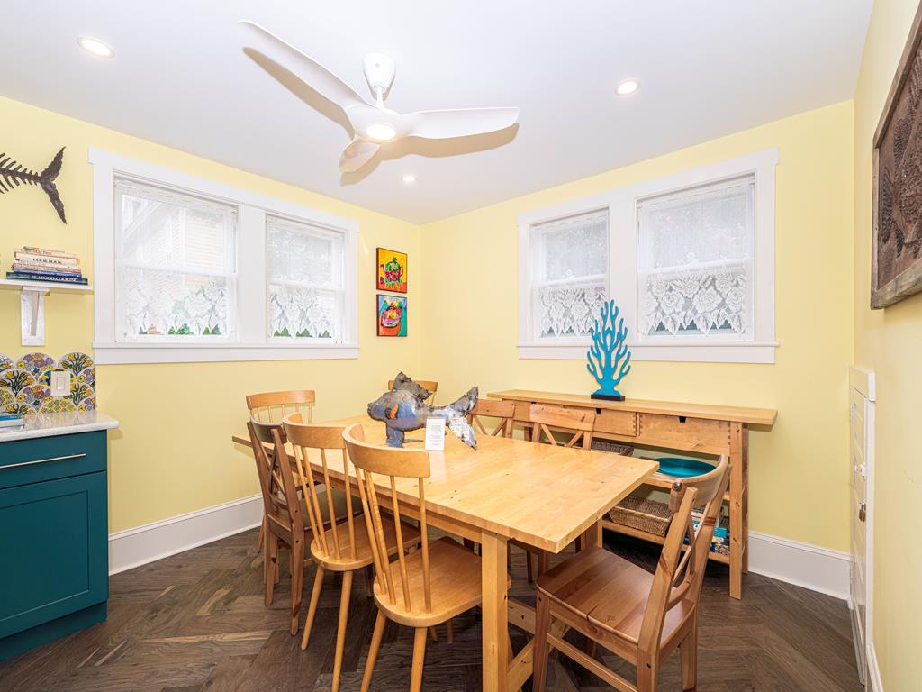 image Spacious dining area with seating for eight, ideal for enjoying home-cooked meals with loved ones.