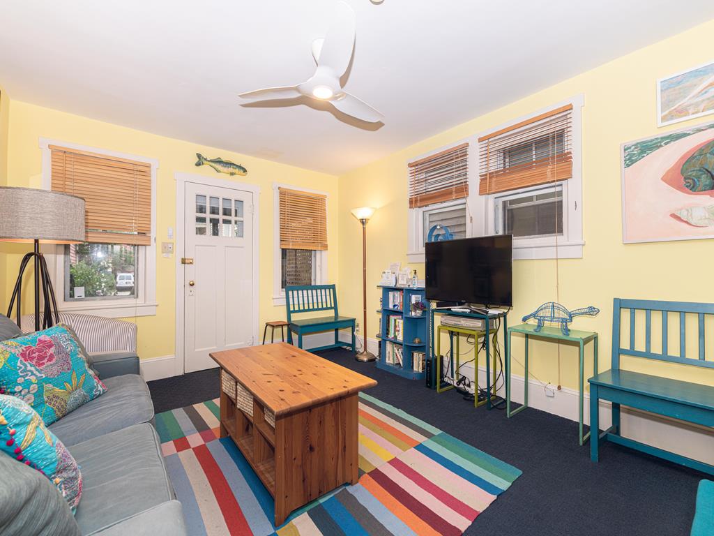 image Cozy living room featuring a bright, welcoming space with colorful decor and ample seating for relaxation.