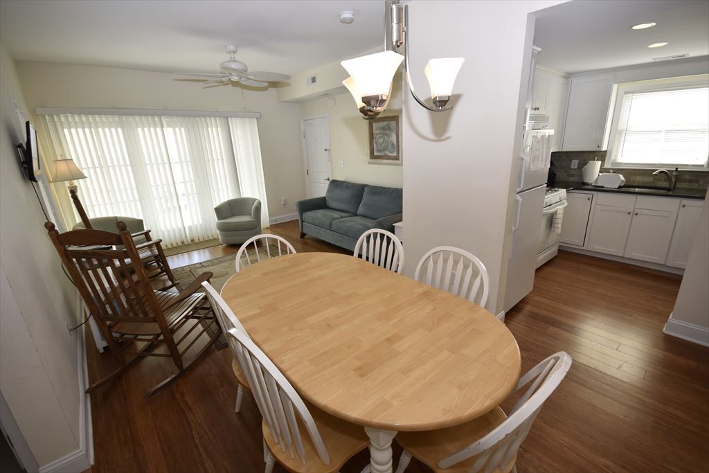 image Bright and inviting dining area perfect for family meals, with easy access to the kitchen and plenty of seating.