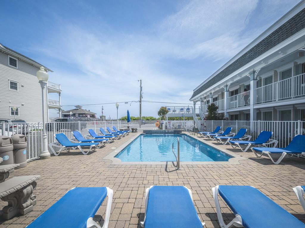 image Take a dip in the community’s heated pool, surrounded by lounge chairs and umbrellas for sunny relaxation.