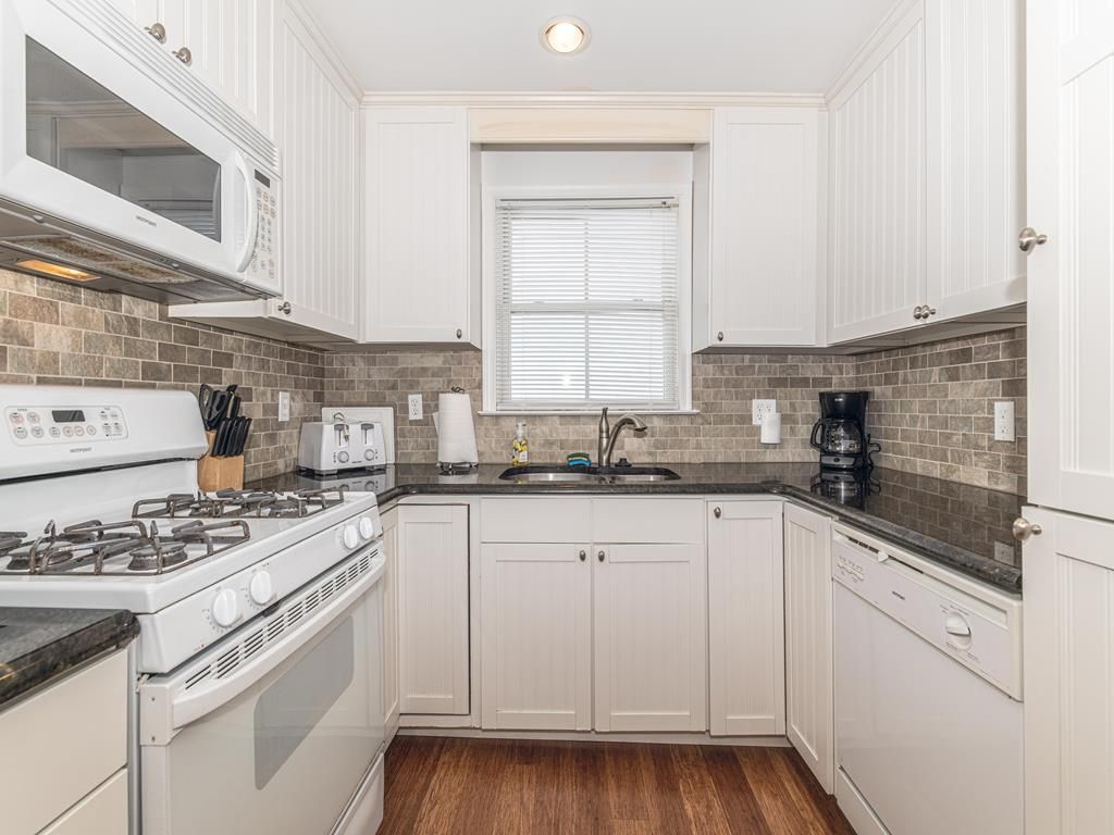 image Cook up family favorites in the modern open-concept kitchen with sleek appliances and ample counter space.