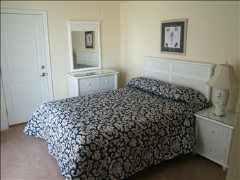 image Spacious and inviting bedroom featuring a Queen bed, elegant decor, and ample storage for your belongings.