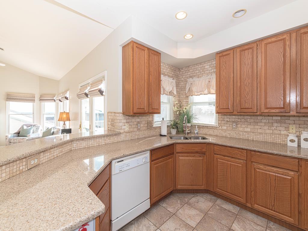 image A closer look at the spacious kitchen, featuring modern appliances and a thoughtful layout.