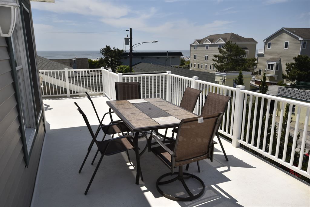 image Spacious deck with outdoor seating and stunning views, ideal for enjoying al fresco dining or morning coffee.
