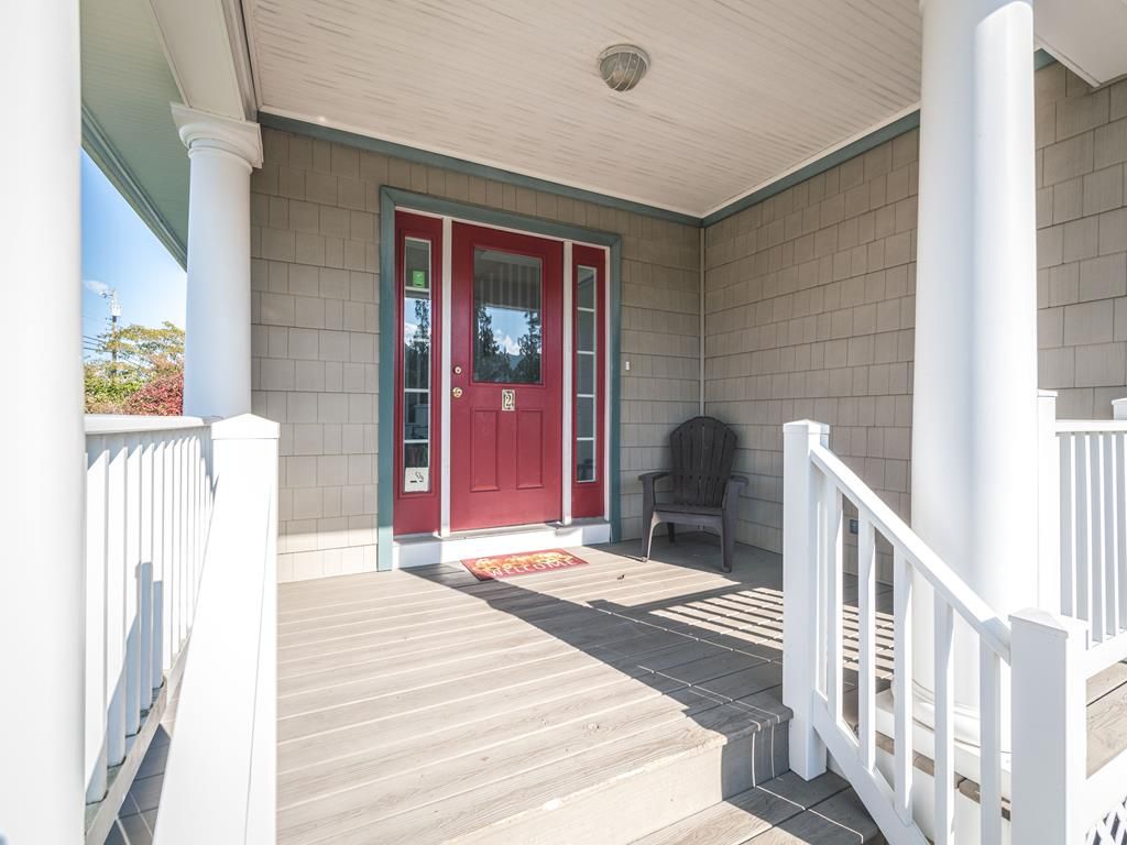 image Welcoming front porch with a cozy seating area, perfect for enjoying your morning coffee.