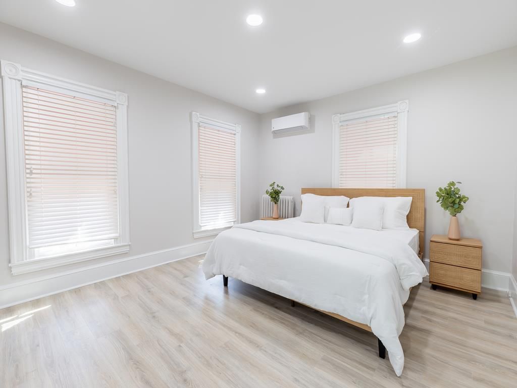 image A spacious and bright bedroom with a large, cozy bed and plenty of natural light for a peaceful ambiance.