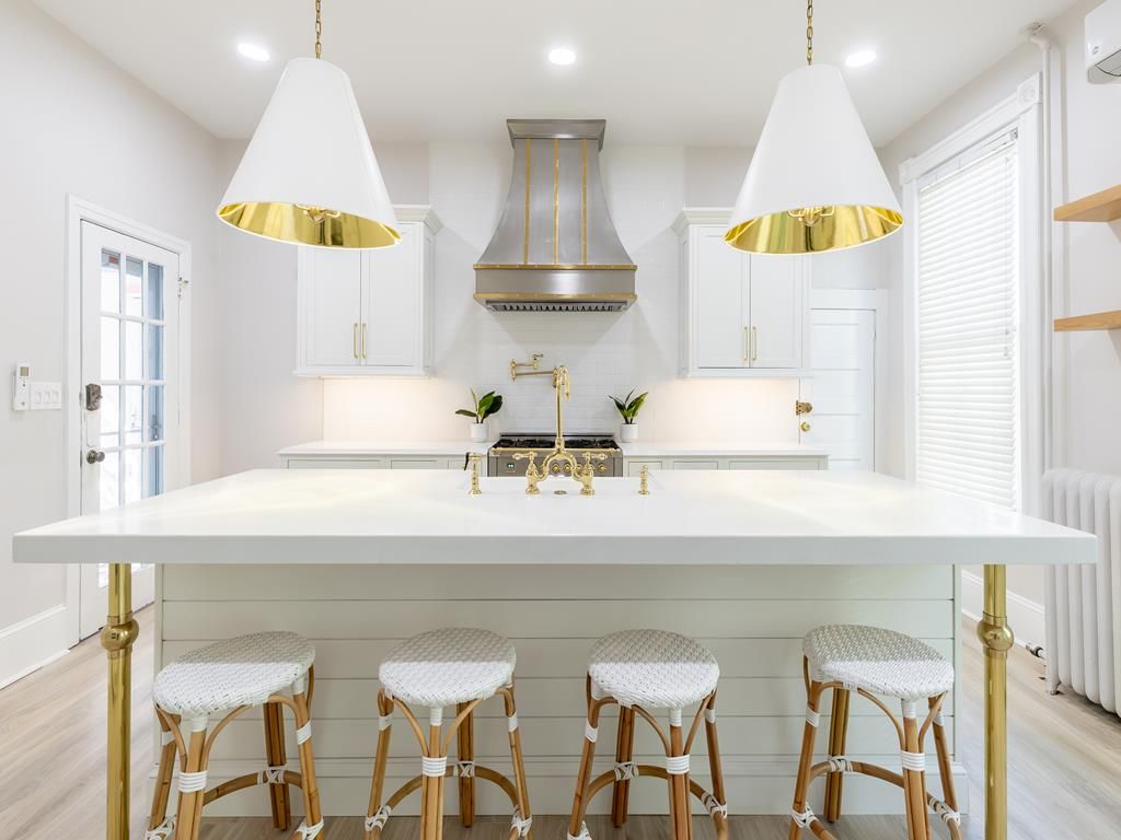 image A bright and airy kitchen with double pendant lighting and a central island, offering both functionality and style for meal prep or casual dining.