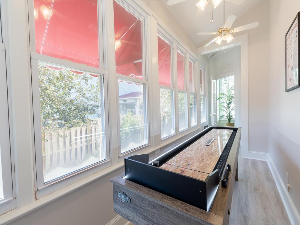 image A bright and airy sunroom with a shuffleboard table, ideal for friendly competitions and enjoying Cape May’s charm.