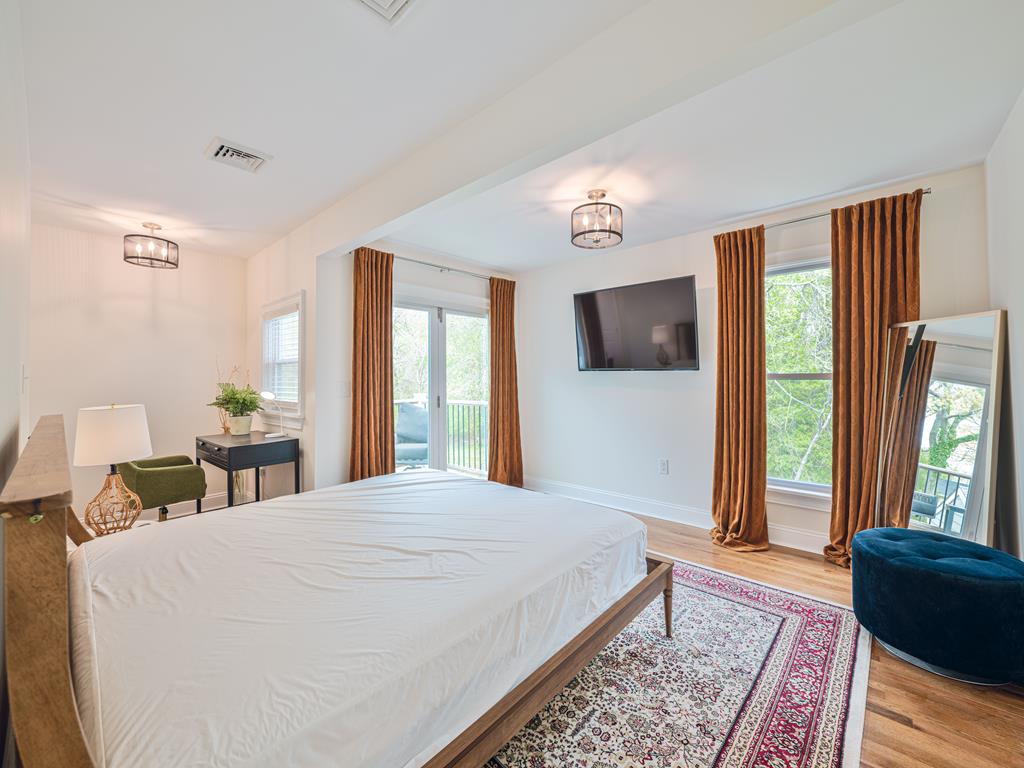 image Spacious and elegant primary suite with large windows, providing abundant natural light and a relaxing atmosphere.