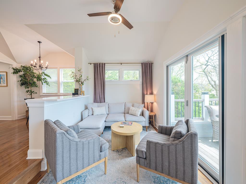 image Cozy living room with modern furnishings and sliding doors leading to the deck for seamless indoor-outdoor living.