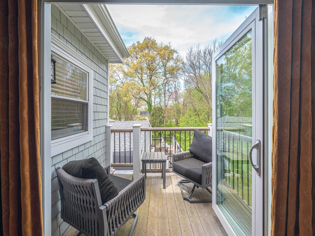 image Inviting upper deck balcony with comfortable seating, perfect for morning coffee surrounded by nature.