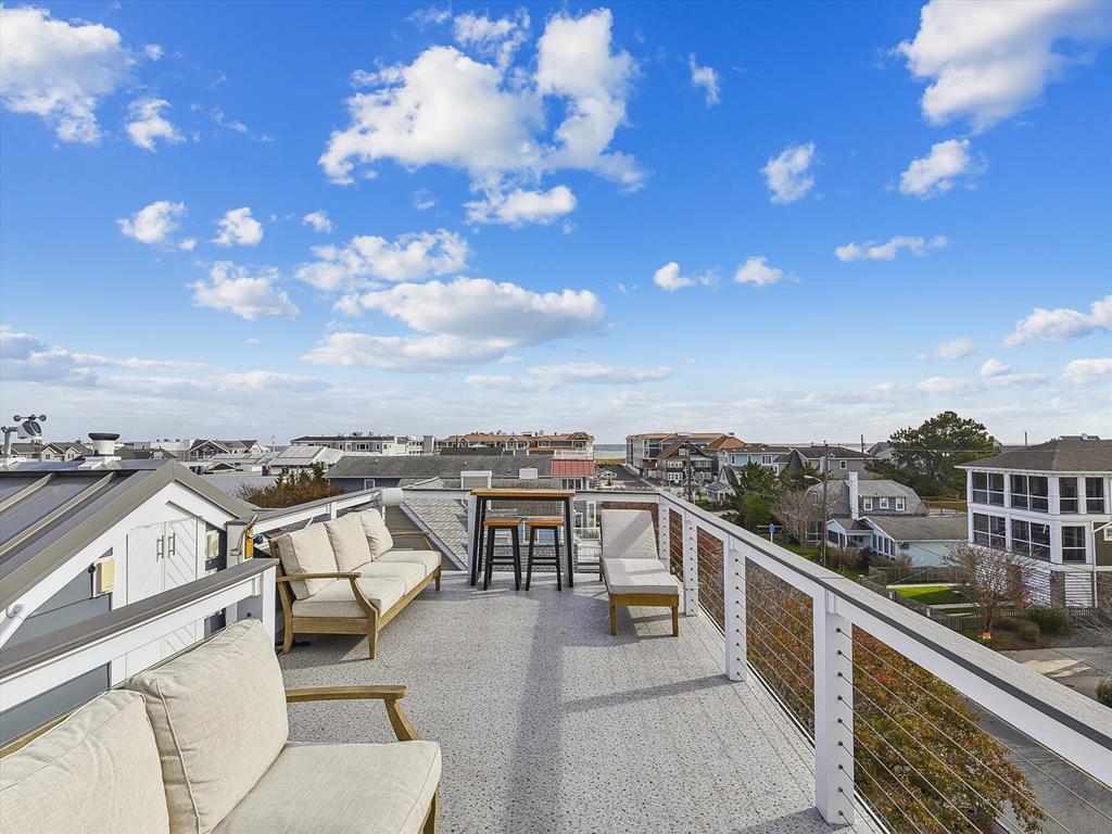 image Enjoy partial ocean and town views from the stunning rooftop observation deck, complete with comfortable seating and space for dining or relaxing.