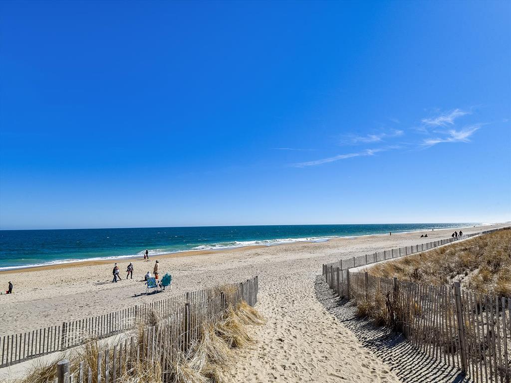 image Scenic view of the nearby beach, highlighting the pristine sand and clear blue waters just steps away.