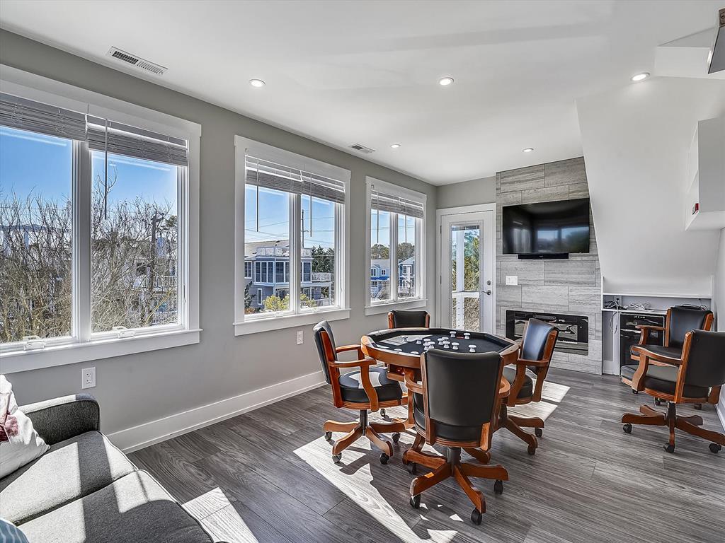 image Cozy sunroom, highlighting the comfy seating area and panoramic windows for enjoying the view as well as a fun game with your loved ones.