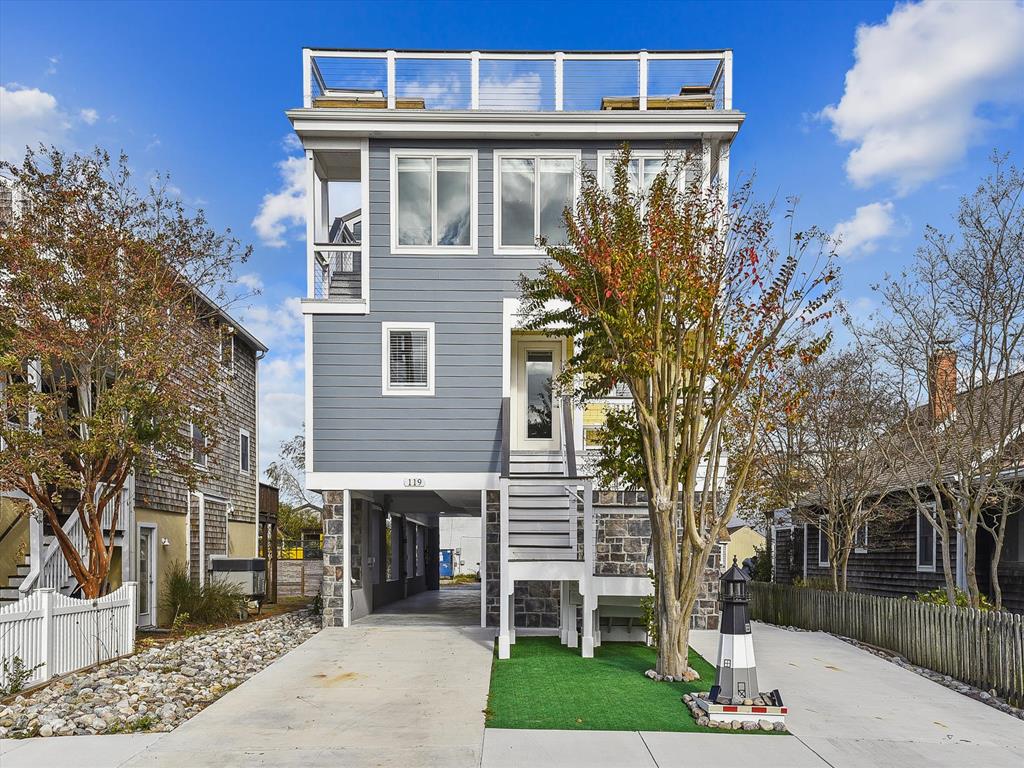 image The stylish exterior of this newly renovated beach block home features ample parking and a clean, modern aesthetic.
