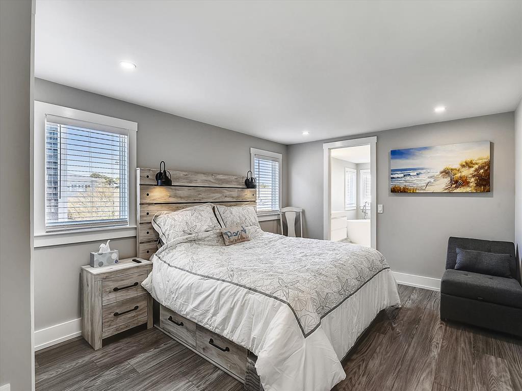 image A serene bedroom with a plush king-sized bed, natural light, and tasteful coastal decor for a restful stay.