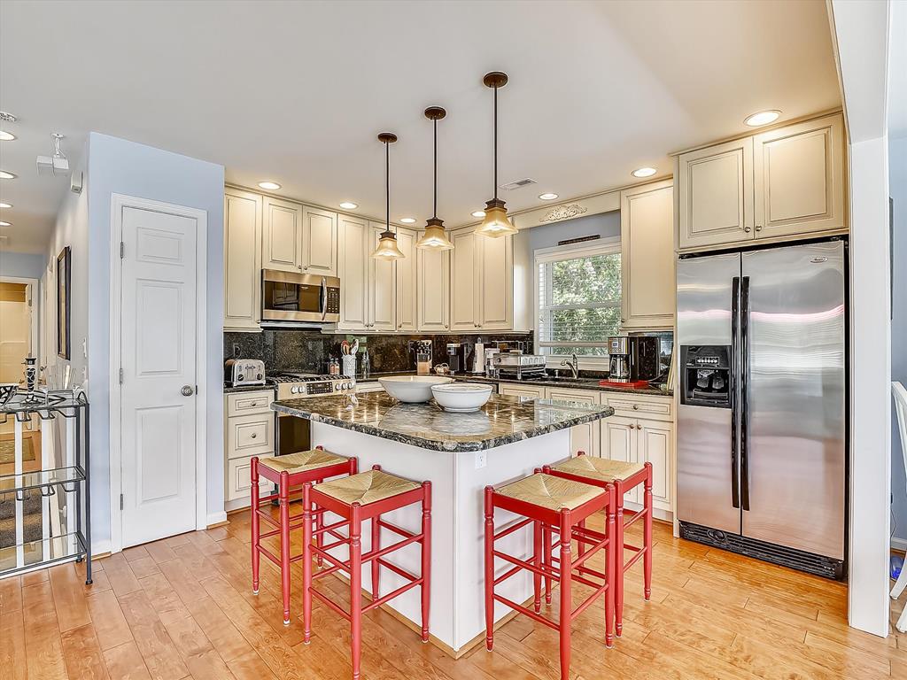 image Central kitchen island with barstools, creating the perfect space for casual breakfasts or evening conversations.