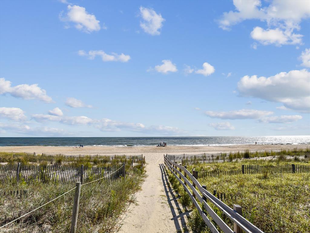 image Picture-perfect beach scene with a clear view of the path to the surf and soft dunes.