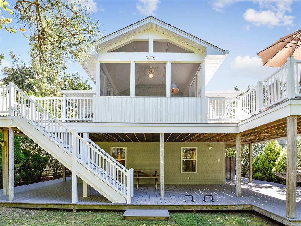 image Bright and inviting front view of the home, surrounded by lush greenery, offering a peaceful retreat.