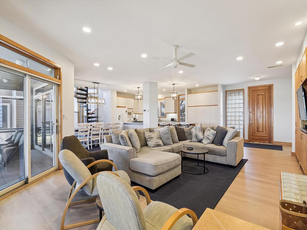 image Spacious and welcoming living room with plush seating and access to the outdoor deck, perfect for entertaining.