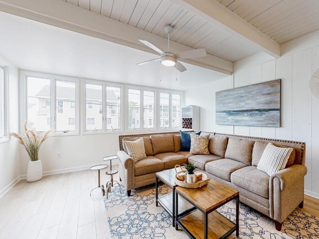 image Spacious and sunlit living area with large windows, creating a bright and inviting space to gather and relax with family and friends.