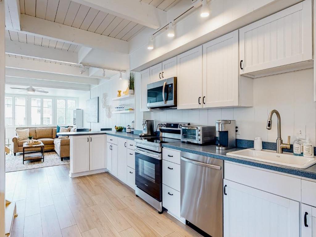 image Bright and spacious kitchen, seamlessly connected to the living area, offering convenience and style for your culinary needs.