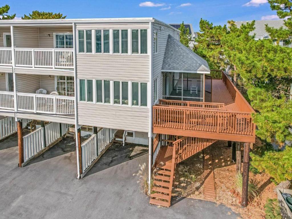 image A view of this expansive five-bedroom townhome, showcasing its impressive multi-level design and ample outdoor space, perfect for beachside relaxation.